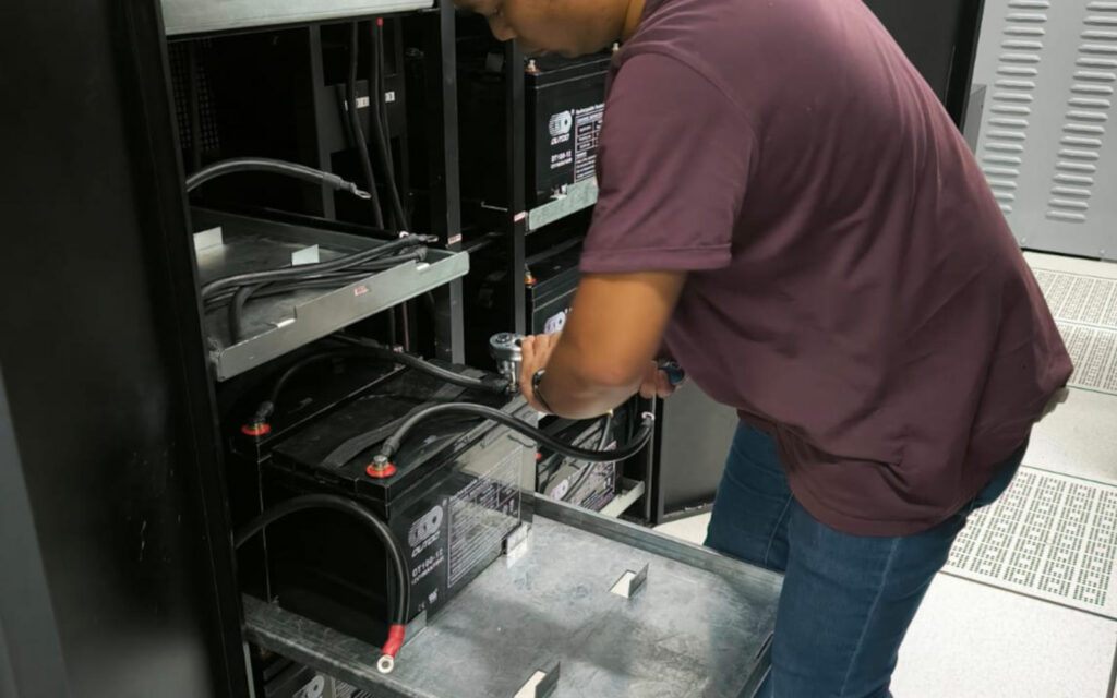 Person Installing A UPS Battery